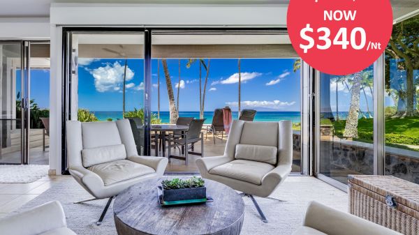 A modern living area with white chairs, a round table, and large windows showing an ocean view. A discounted price of $340 per night is displayed.