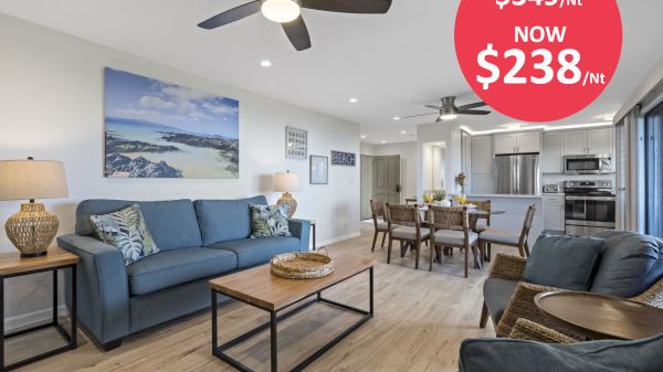 A modern, open-concept living and dining area with stylish furnishings, and a discounted rate advertised from $349 to $238 per night.