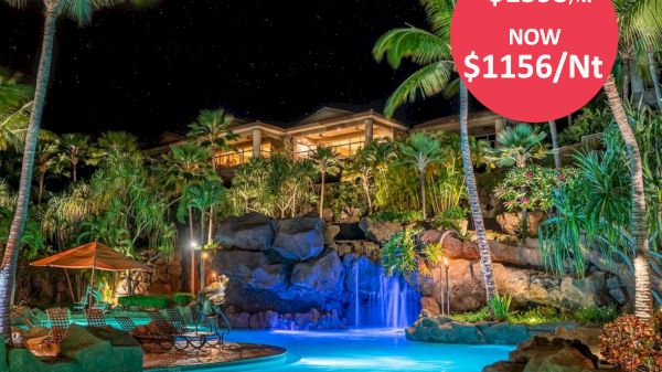 A tropical resort at night with a pool, waterfall, palm trees, and discount prices. Was $1595/Nt, now $1156/Nt, displayed in a red circle.