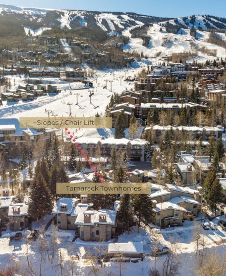 The image shows a winter resort area with slopes, a chair lift, and Tamarack Townhomes surrounded by snowy mountains and trees.